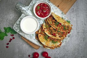 quesadillas beside salsa and mayonnaise on cups